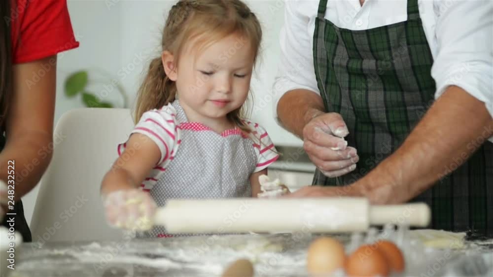Mother Helps Her Daughter Knead the Dough. They Have a Lot of Fun Together. Mother Helps Her Daughter Knead the Dough. They Have a Lot of Fun Together.