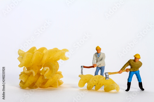 Conceptual diorama image of miniature figures shaping fusilli pasta