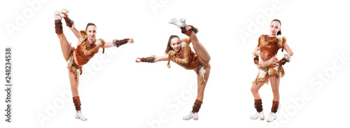cheerleader dressed in a warrior costume stands in vertical splits  girl doing acrobatic and flexible tricks  dancer practicing mixed dance and stretching  extending leg up  vertical twine  image set