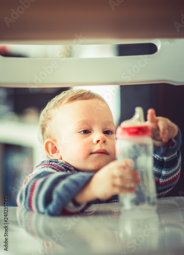 Baby looking in his empty bottle