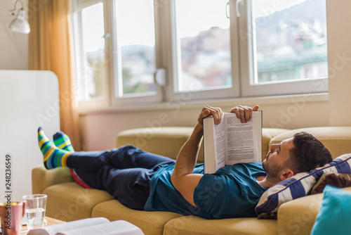 Wall Mural Interested man reading a book