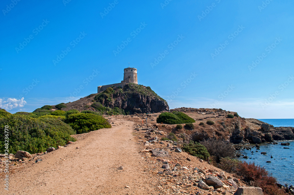 An old tower on the coast of the island of Sardinia, formerly a military watchtower.