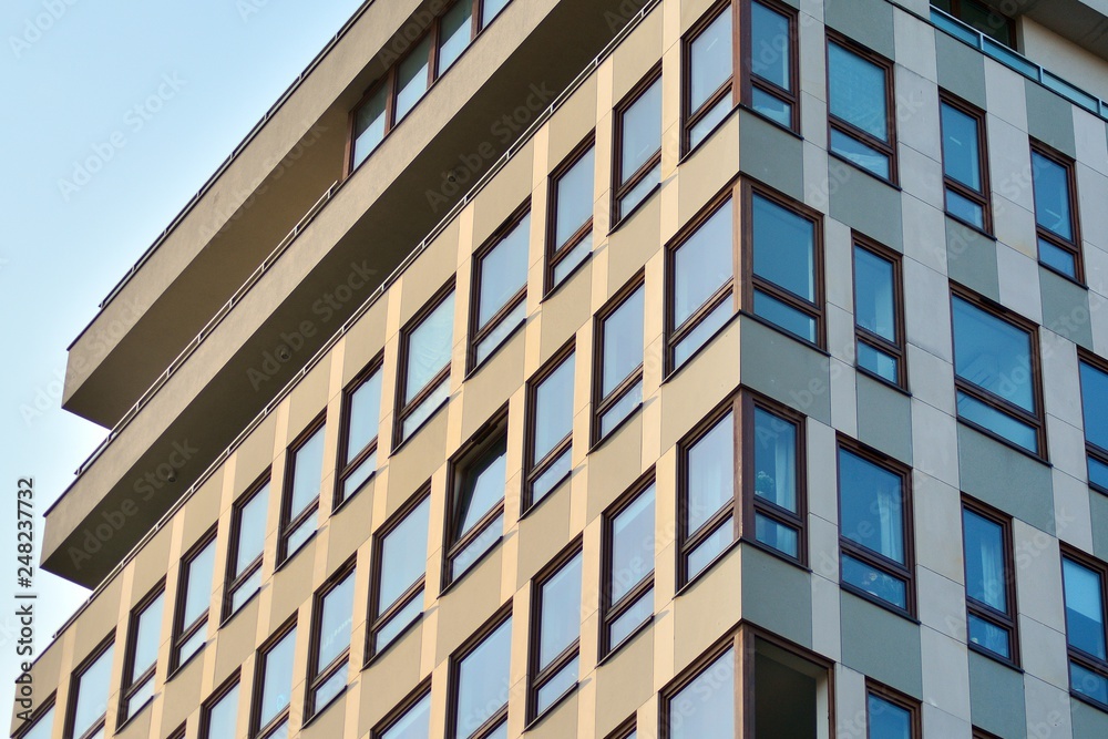 Modern apartment buildings on a sunny day with a blue sky. Facade of a modern apartment building Modern apartment buildings on a sunny day with a blue sky. Facade of a modern apartment building