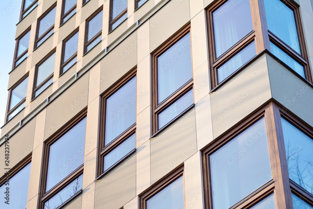 Modern apartment buildings on a sunny day with a blue sky. Facade of a modern apartment building Modern apartment buildings on a sunny day with a blue sky. Facade of a modern apartment building