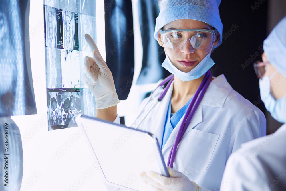 Two female women medical doctors looking at x-rays in a hospital. Two female women medical doctors looking at x-rays in a hospital.