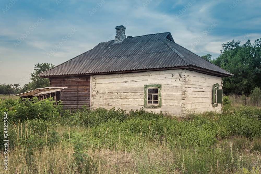 Fototapeta premium Old wooden country house with old shutters