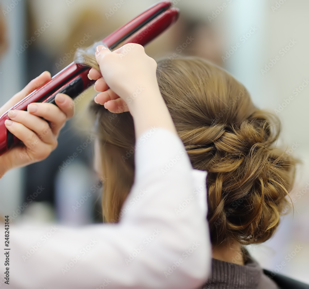 Naklejka premium Young woman/bride getting her hair done before wedding, bachelorette or party