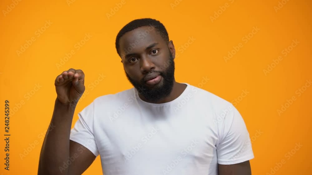 Irritated Afro-American man showing blah blah gesture, annoyed with conversation