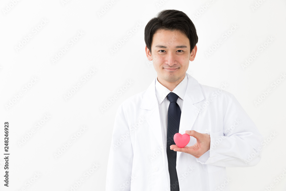 portrait of young asian doctor holding heart symbol isolated on white background portrait of young asian doctor holding heart symbol isolated on white background