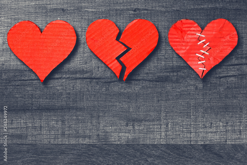 Three hearts healthy / broken / stitched on wooden background with copy space. Valentine's Day Three hearts healthy / broken / stitched on wooden background with copy space. Valentine's Day