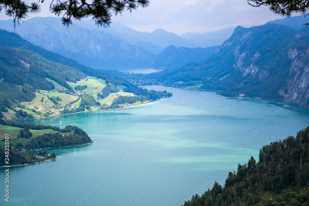 Mondsee lake, Austria - aerial view from Drachenwand ridge showing turquoise waters with mountains in the background. Summer holiday destination in Austria. Copy space.