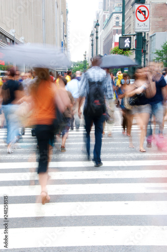 People crossing a street on a city's designated pedestrian lane.