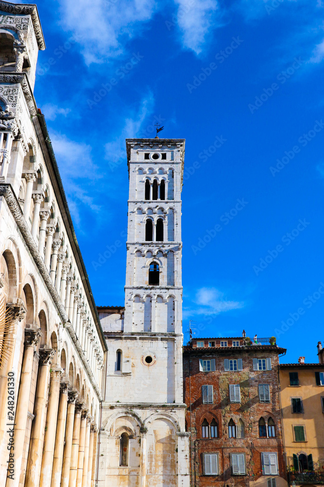 View to bell tower of San Michele in Foro church on the clear blue sky background, Lucca, Tuscany, Italy