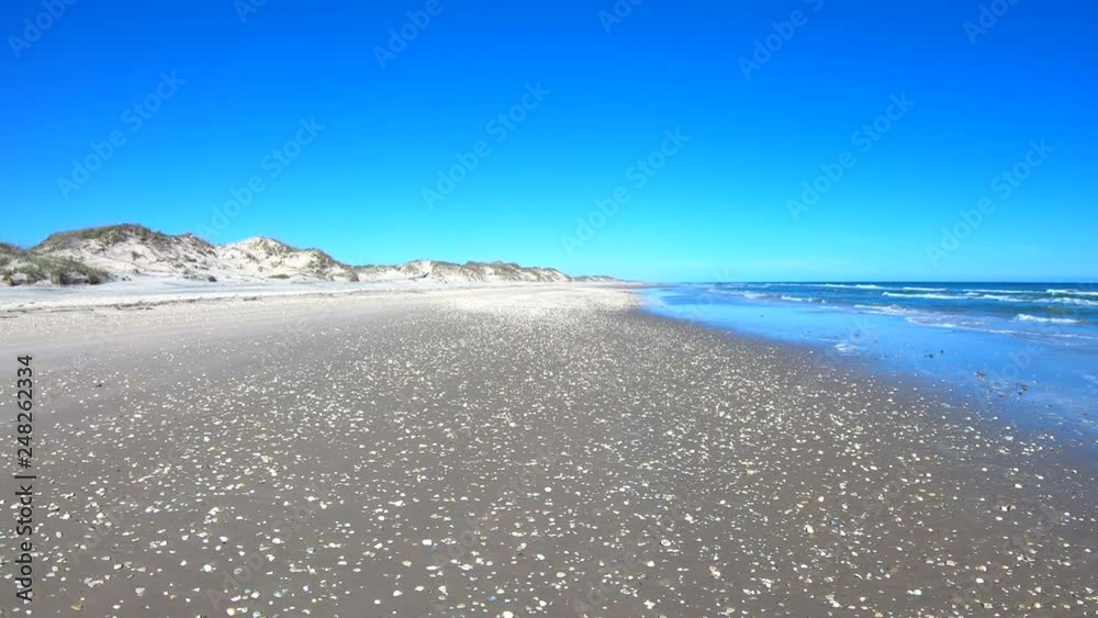 Sand and seashells Texas ocean beach driving POV. Beautiful southern