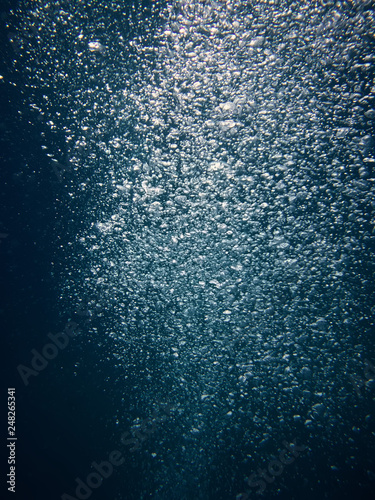 scooba diver bubbles upcoming from a deep sea