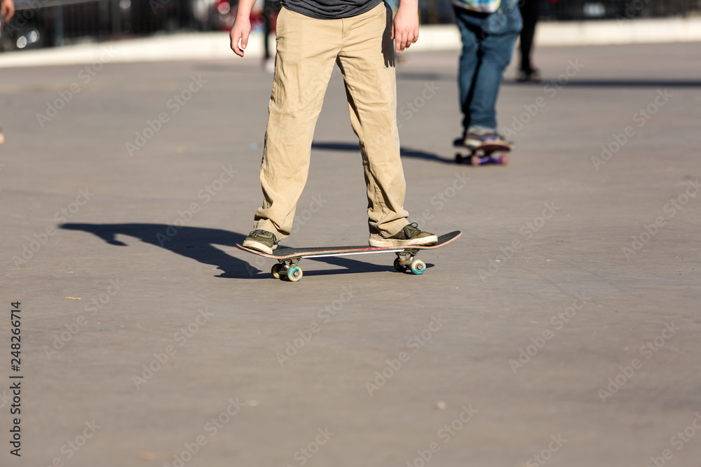 Person riding a skate board in an urban asphalt park Person riding a skate board in an urban asphalt park