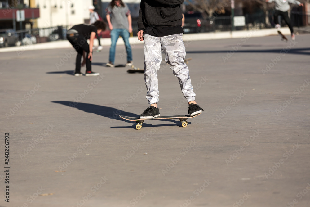 Obraz premium Person riding a skate board in an urban asphalt park