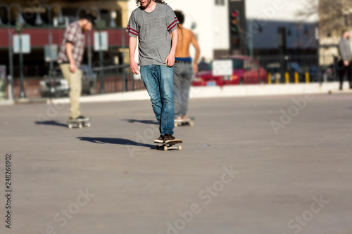 Person riding a skate board in an urban asphalt park