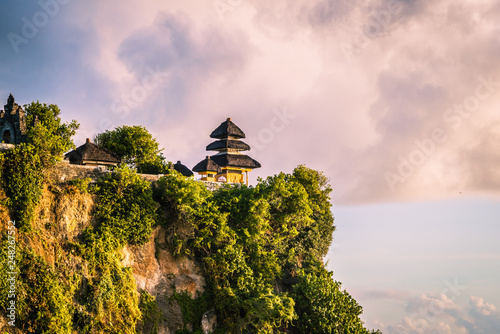 Uluwatu Temple on cliff with clouds photo