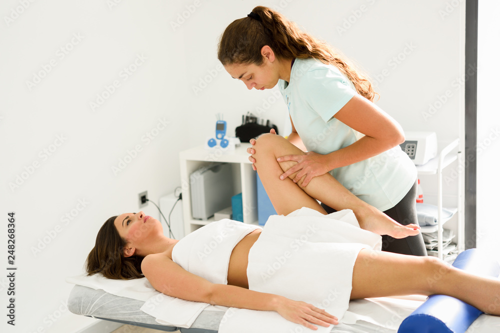 Medical massage at the leg in a physiotherapy center. Medical massage at the leg in a physiotherapy center.