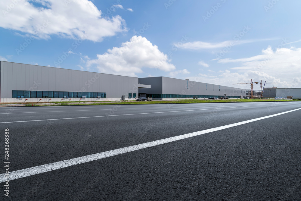 Road asphalt pavement and modern factory warehouse.. Road asphalt pavement and modern factory warehouse..