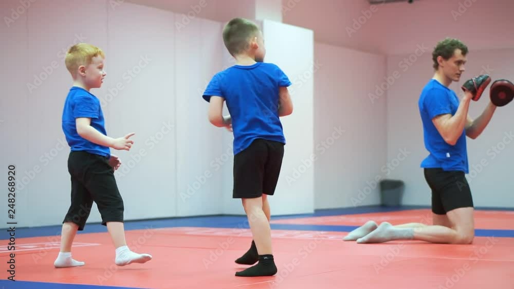 Boys engaged in hand-to-hand combat, the coach teaches exercises. Boys engaged in hand-to-hand combat, the coach teaches exercises.