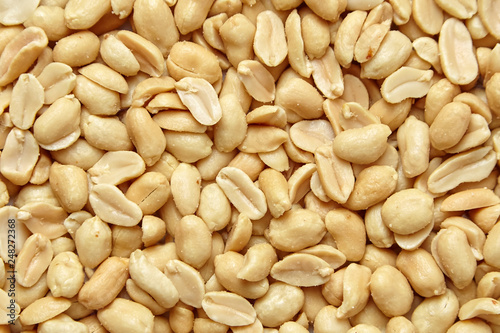 roasted peanuts, salted snack as background, top view