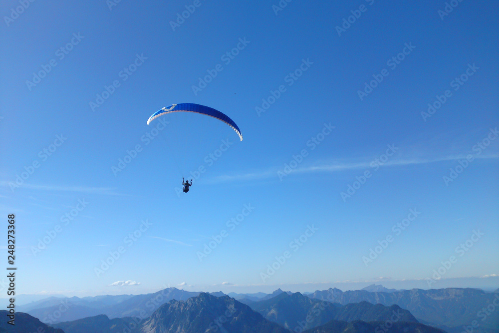 Paragliding above Alps mountain range from Dachstein, Austria Paragliding above Alps mountain range from Dachstein, Austria