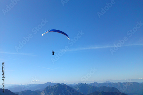 Paragliding above Alps mountain range from Dachstein  Austria