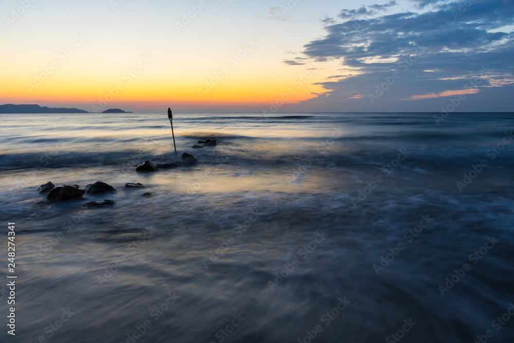 Romantic endless blue ocean in magic orange sunset light