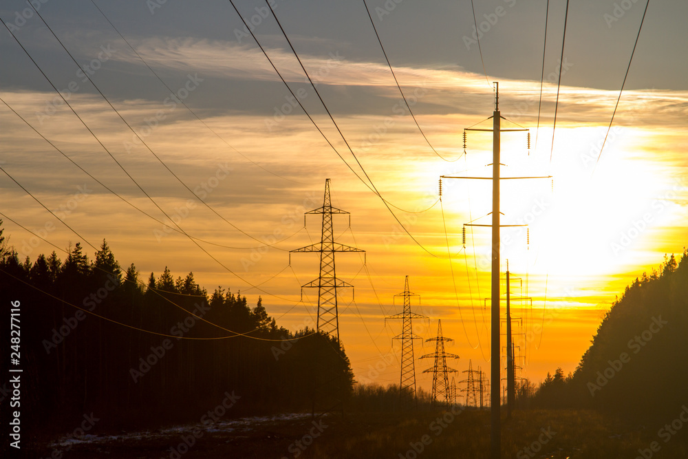 High-voltage power lines at sunset