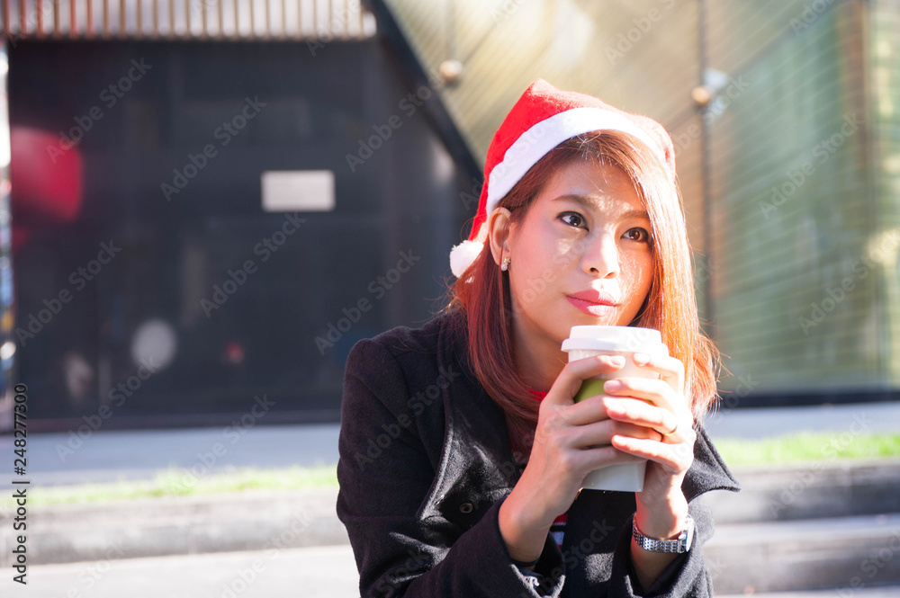 Portrait of beautiful smiling woman on the christmas time with her cup of coffee in hands,Selective focus Portrait of beautiful smiling woman on the christmas time with her cup of coffee in hands,Selective focus