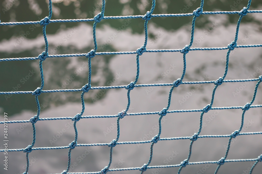 Fototapeta premium Green mesh rope for aquatic animals on the farm.