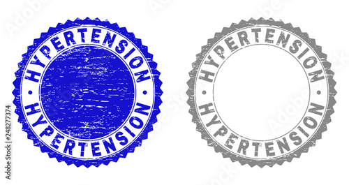 Grunge HYPERTENSION stamp seals isolated on a white background. Rosette seals with distress texture in blue and gray colors. Vector rubber stamp imitation of HYPERTENSION caption inside round rosette.