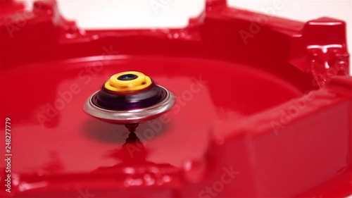 Popular Modern Children Game Beyblade Burst Fast spinning on red arena.