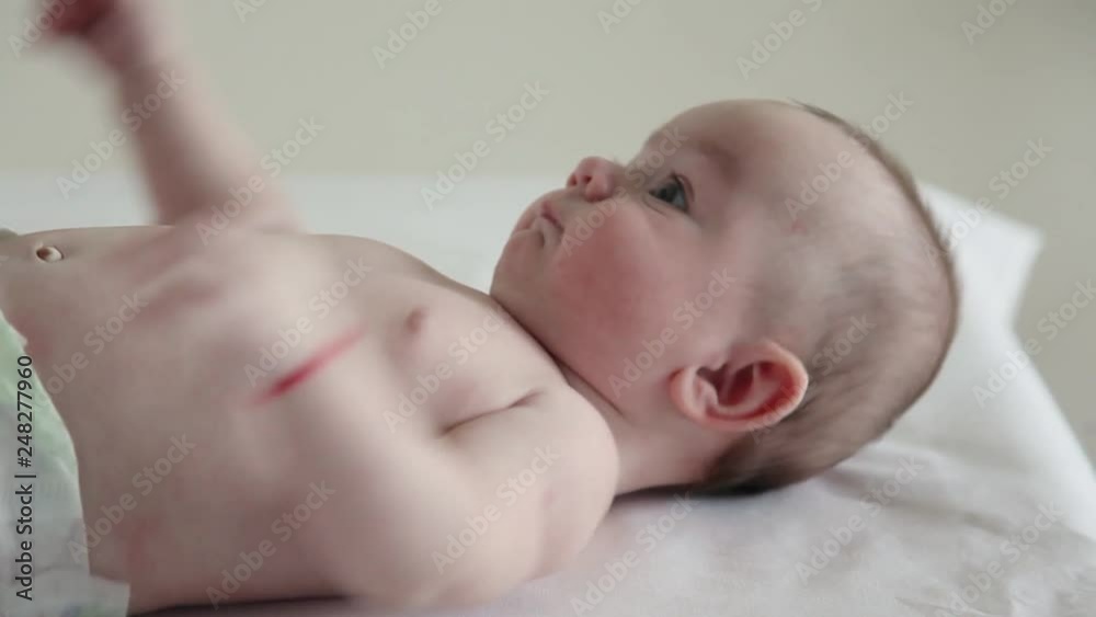 Beautiful baby lying on his back waving its legs Beautiful baby lying on his back waving its legs