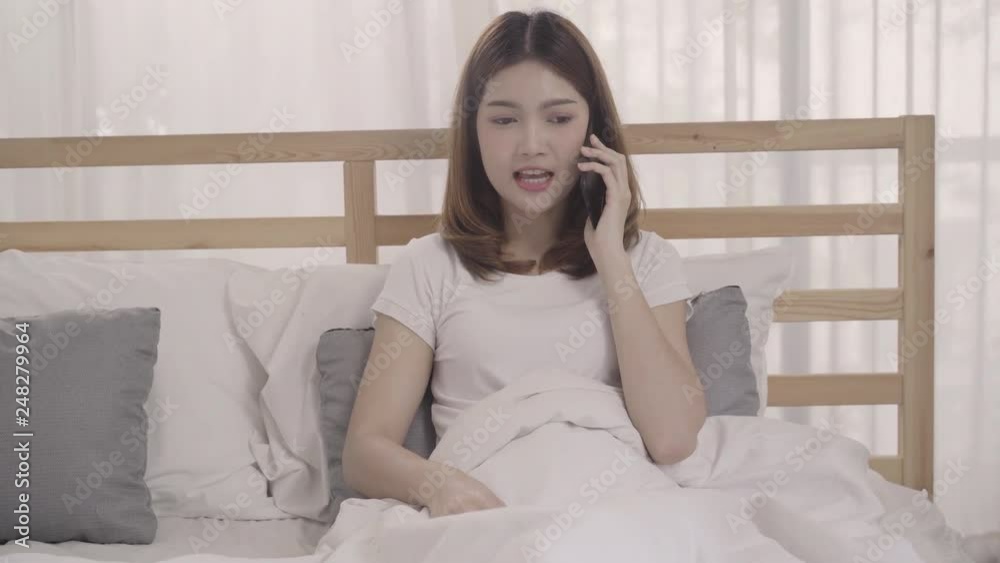 Young Asian woman using smartphone while lying on bed after wake up in the morning, Beautiful attractive Japanese girl smiling relax in bedroom at home. Enjoying time lifestyle women at home concept. Young Asian woman using smartphone while lying on bed after wake up in the morning, Beautiful attractive Japanese girl smiling relax in bedroom at home. Enjoying time lifestyle women at home concept.