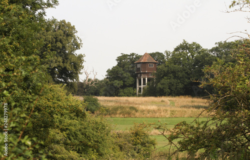 A landscape view of the old derelict Briggen's Water Tower at Hunsdon Mead, England, United Kingdom. photo