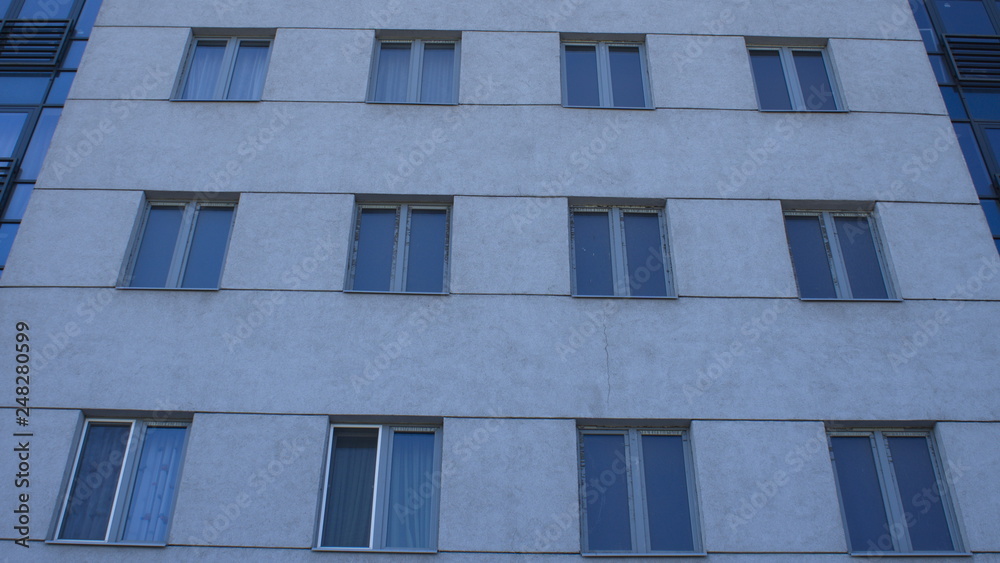 Gray modern building facade with new pvc windows