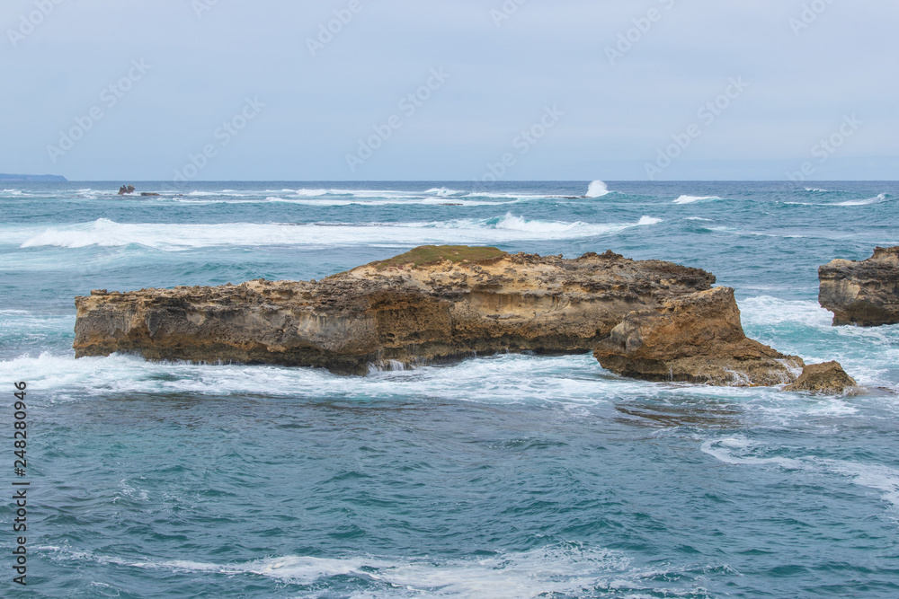 Circular shaped rocks on the ocean.