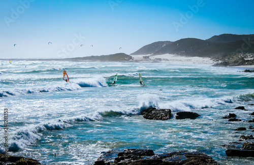 People windsurfing on a beach in the Cape of Good Hope National Park near Cape Town, South Africa