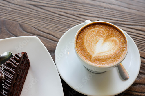 Wallpaper Mural Cappuccino coffee in white cup lay on wooden table,Relax time with coffee and chocolate cake,Art of coffee,Chocolate cake put on wooden table Torontodigital.ca