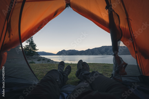 Camping view with legs by the lake New Zealand