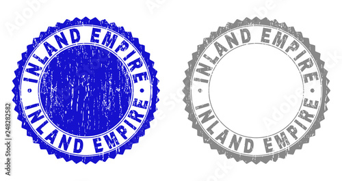 Grunge INLAND EMPIRE stamp seals isolated on a white background. Rosette seals with grunge texture in blue and gray colors. Vector rubber stamp imitation of INLAND EMPIRE text inside round rosette.