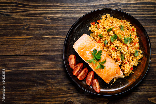 Roast salmon with groats and vegetables