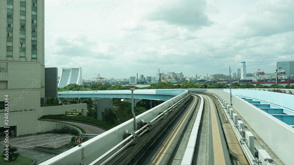 Fototapeta premium Railway of Yurikamome Train system in Tokyo Japan. Turn in the Road