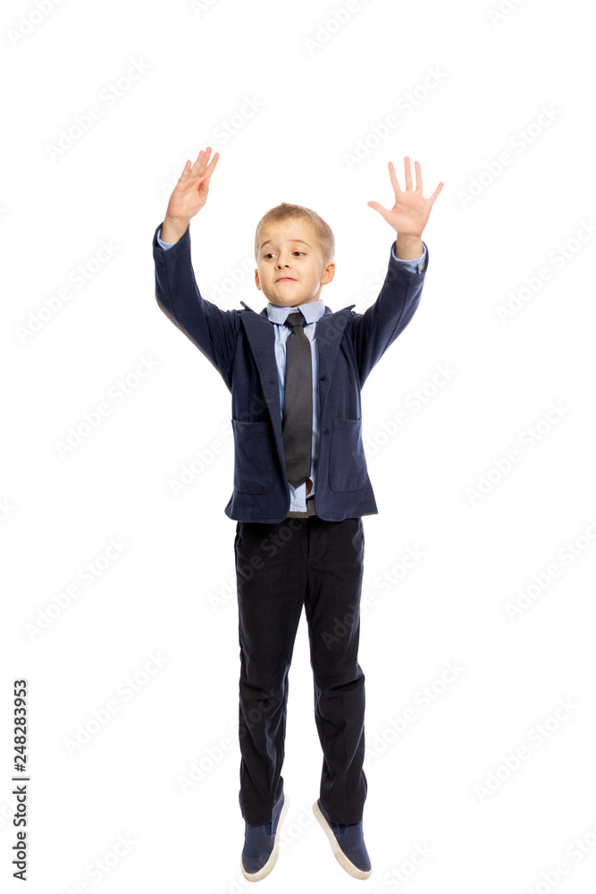 Boy in school uniform jumping, isolated on white background, vertical Boy in school uniform jumping, isolated on white background, vertical