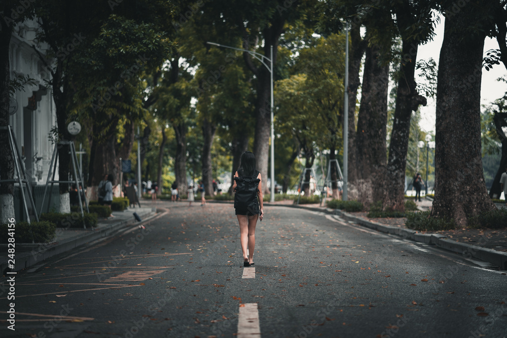 Fototapeta premium Woman backpacker exploring Hanoi street Vietnam