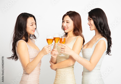 three female Friends Make Toast and Celebrate At Party