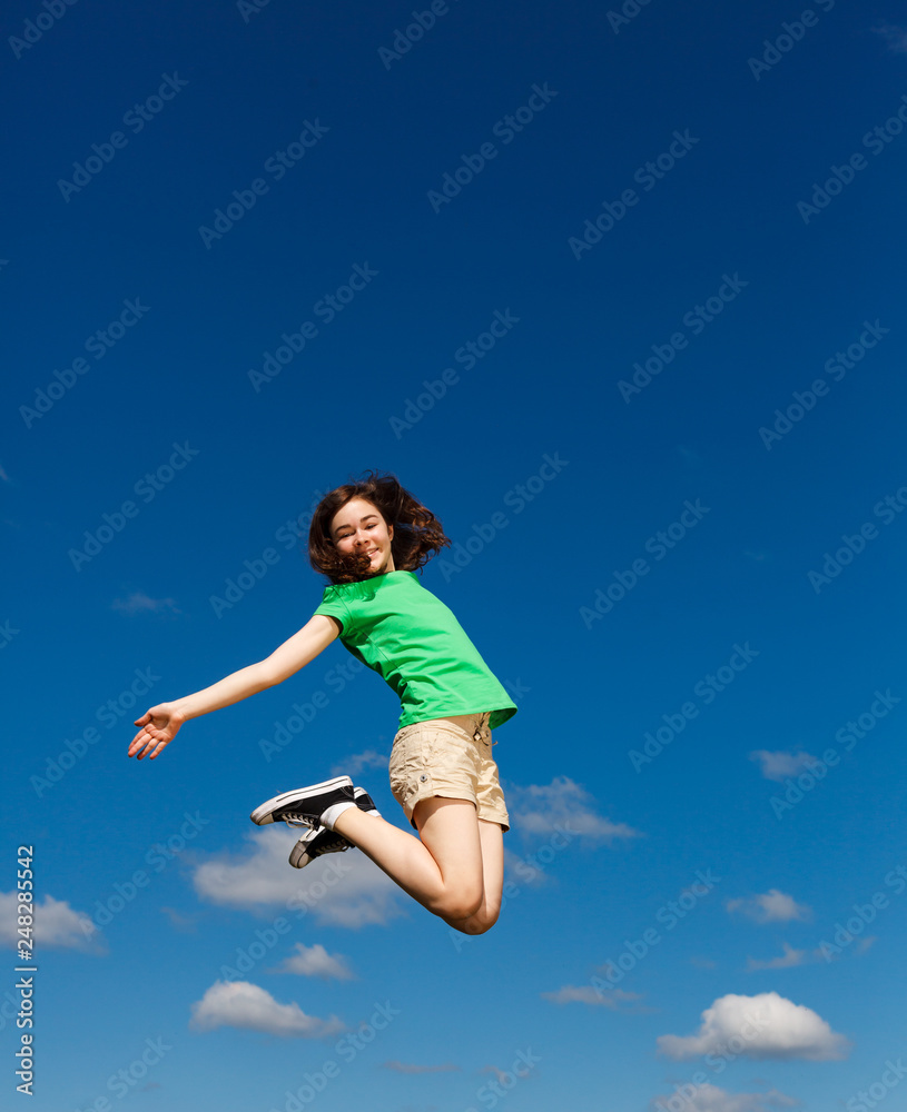 Girl jumping, running against blue sky Girl jumping, running against blue sky